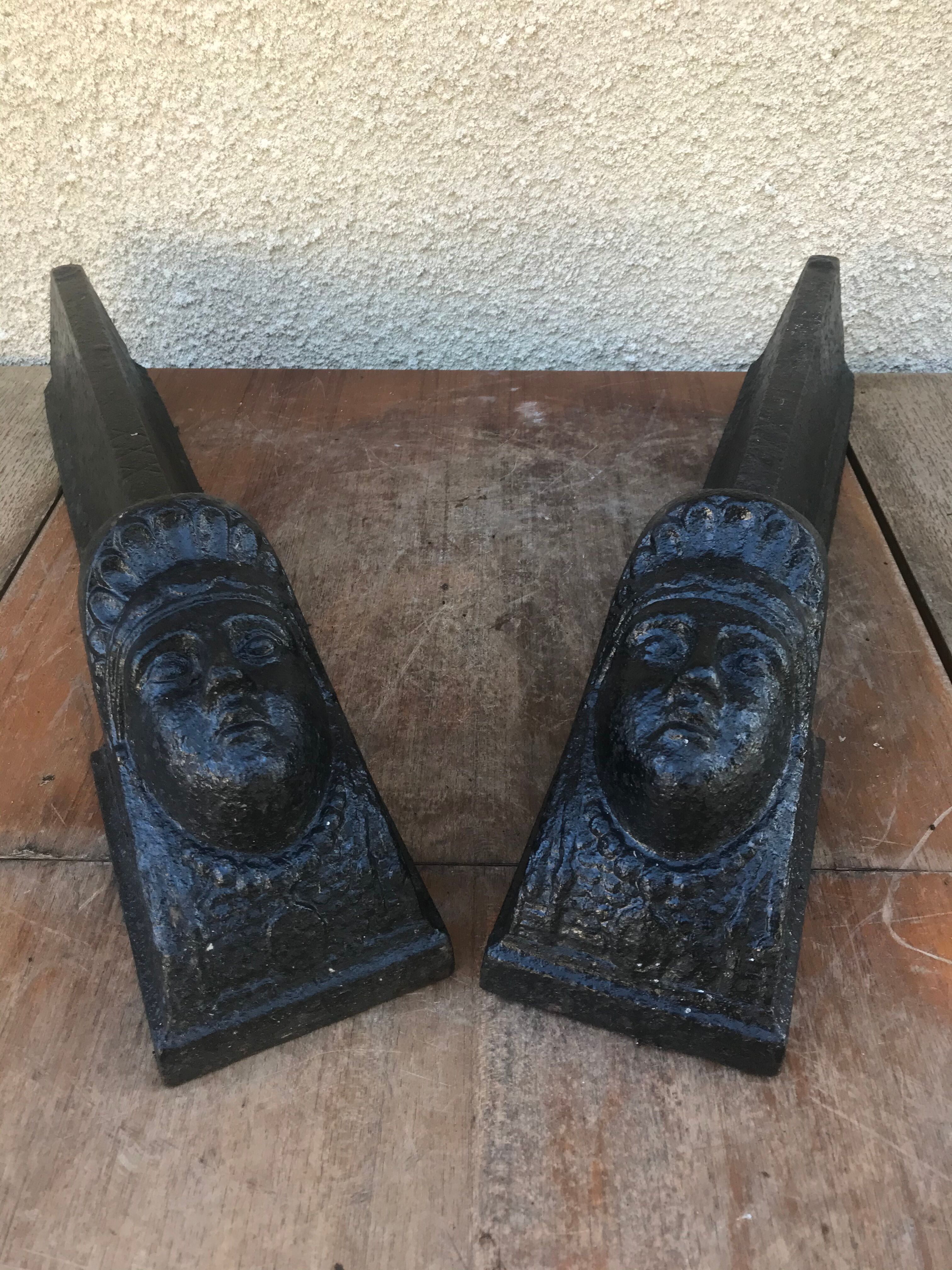 Old pair of chimney caterpillars shape of the head of a woman in iron