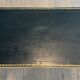 Neoclassical brass coffee table with a black leather top and golden borders from Maison Jansen.