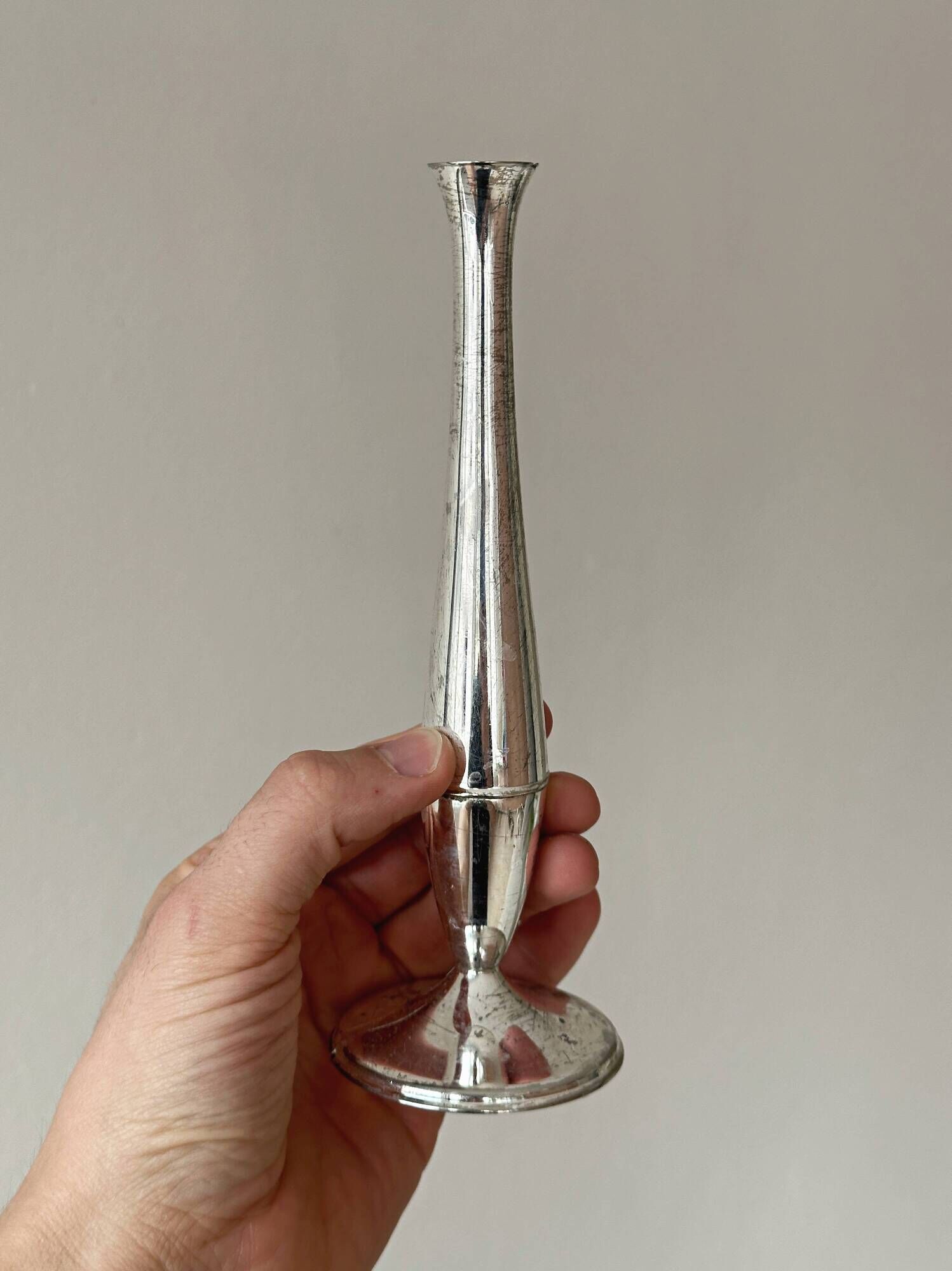 Set of three lightweight silver-coloured metal vases.