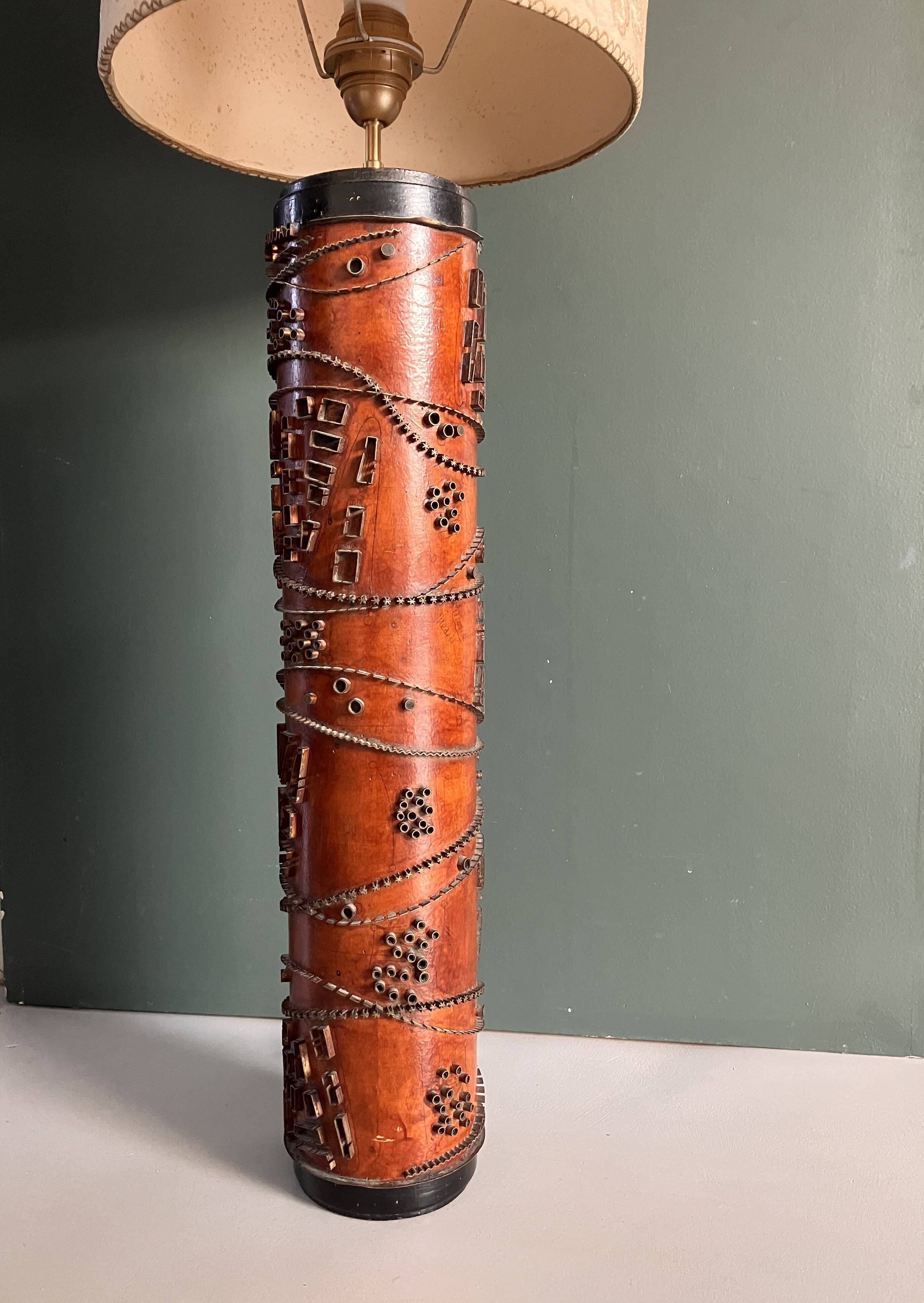 Table lamp with a solid wood printing roll and floral lampshade.