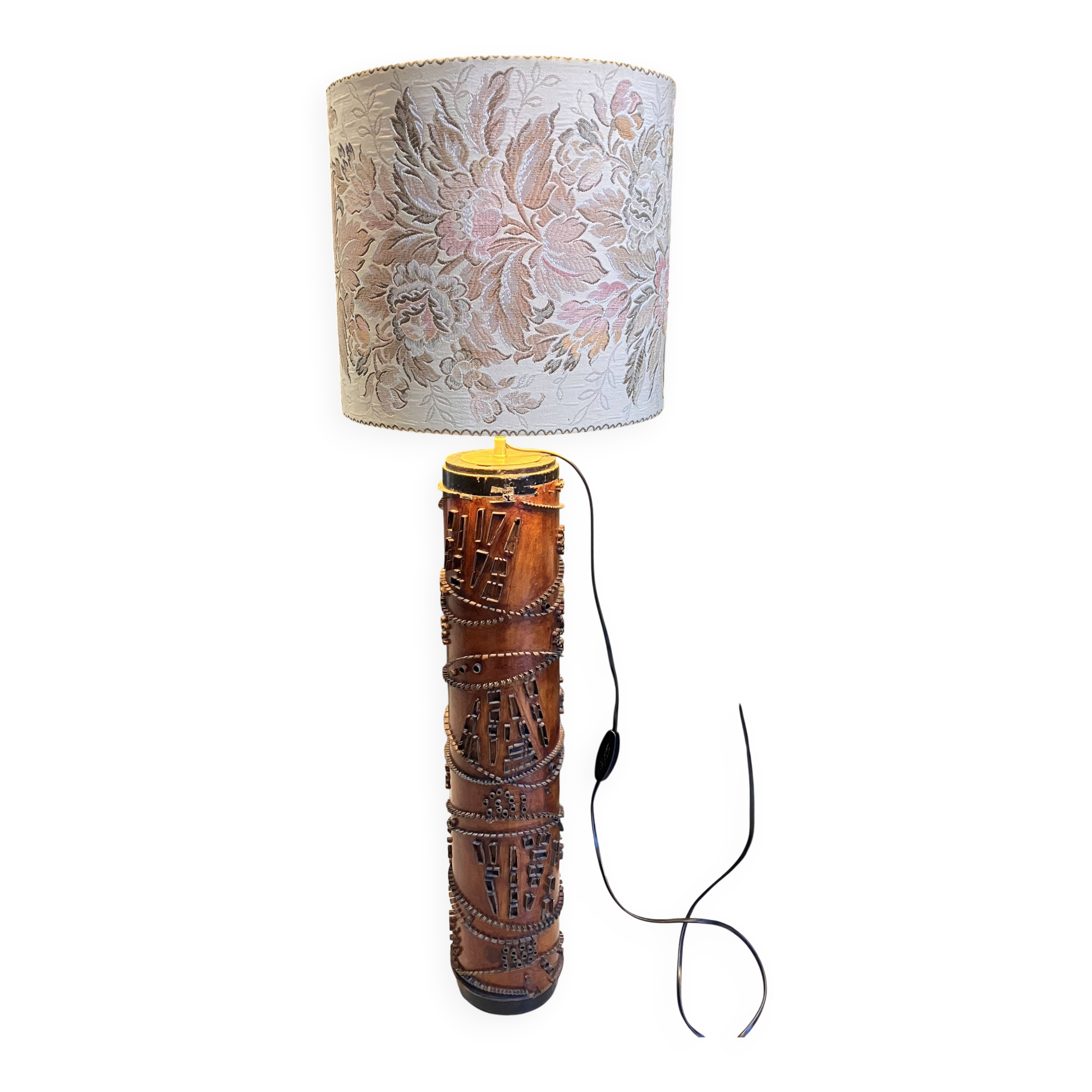 Table lamp with a solid wood printing roll and floral lampshade.