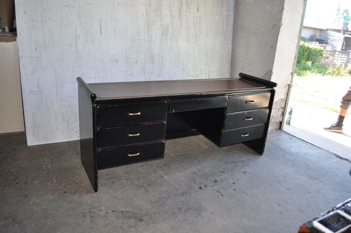 Hungarian Art Deco desk in black painted wood with a brown top and metal handles.