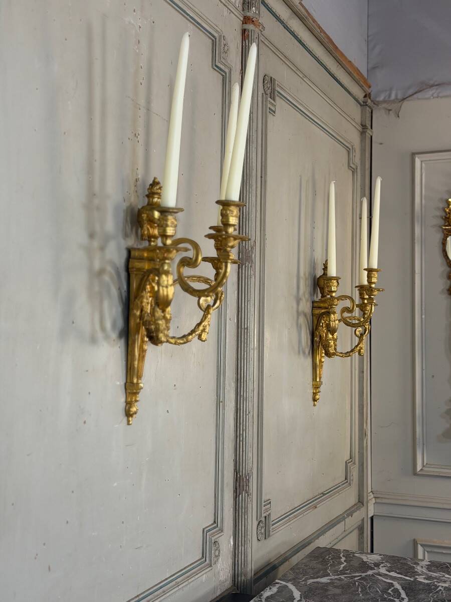 Pair of Louis XVI style wall sconces in gilded bronze, circa 1880.