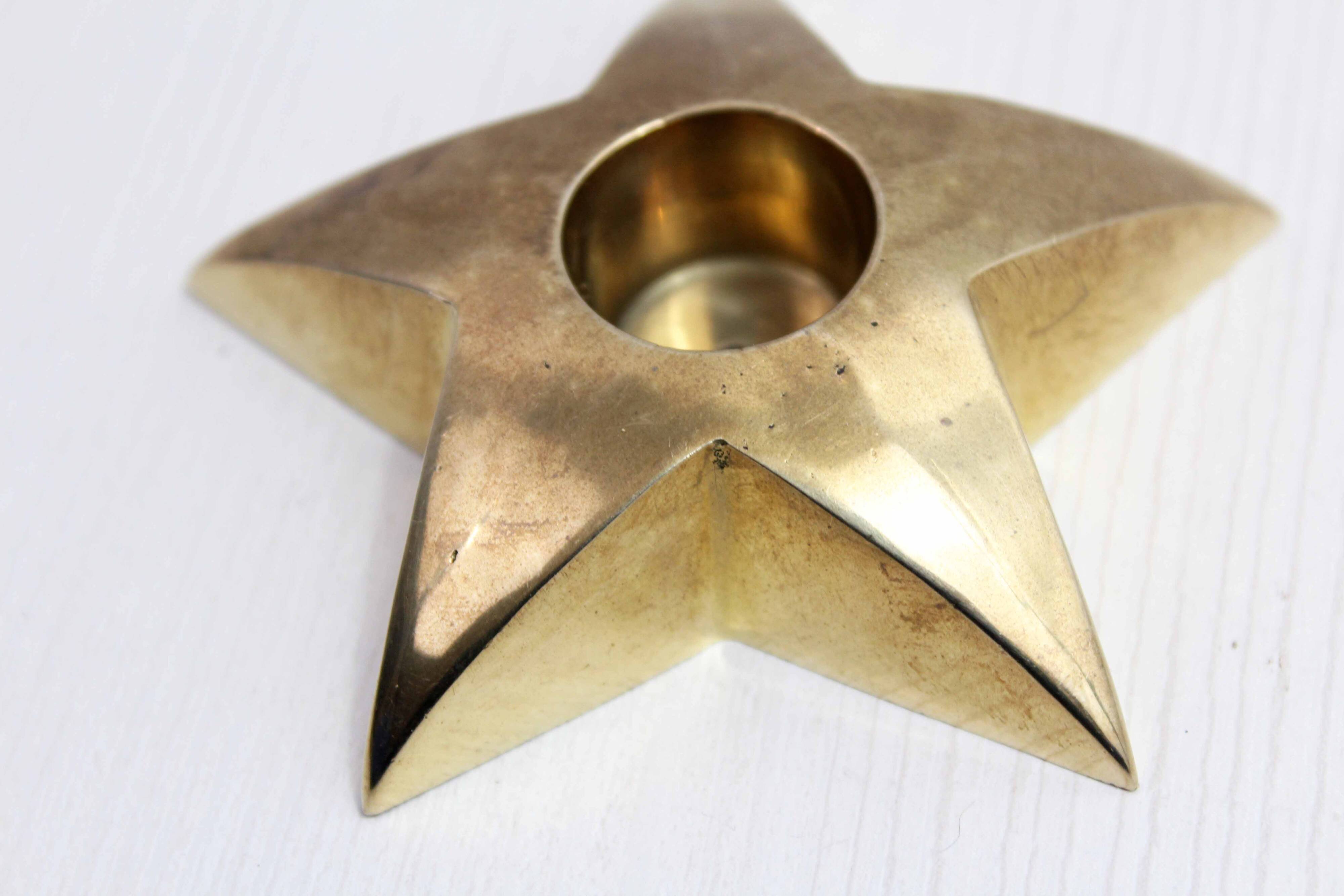 Star-shaped brass candle holder