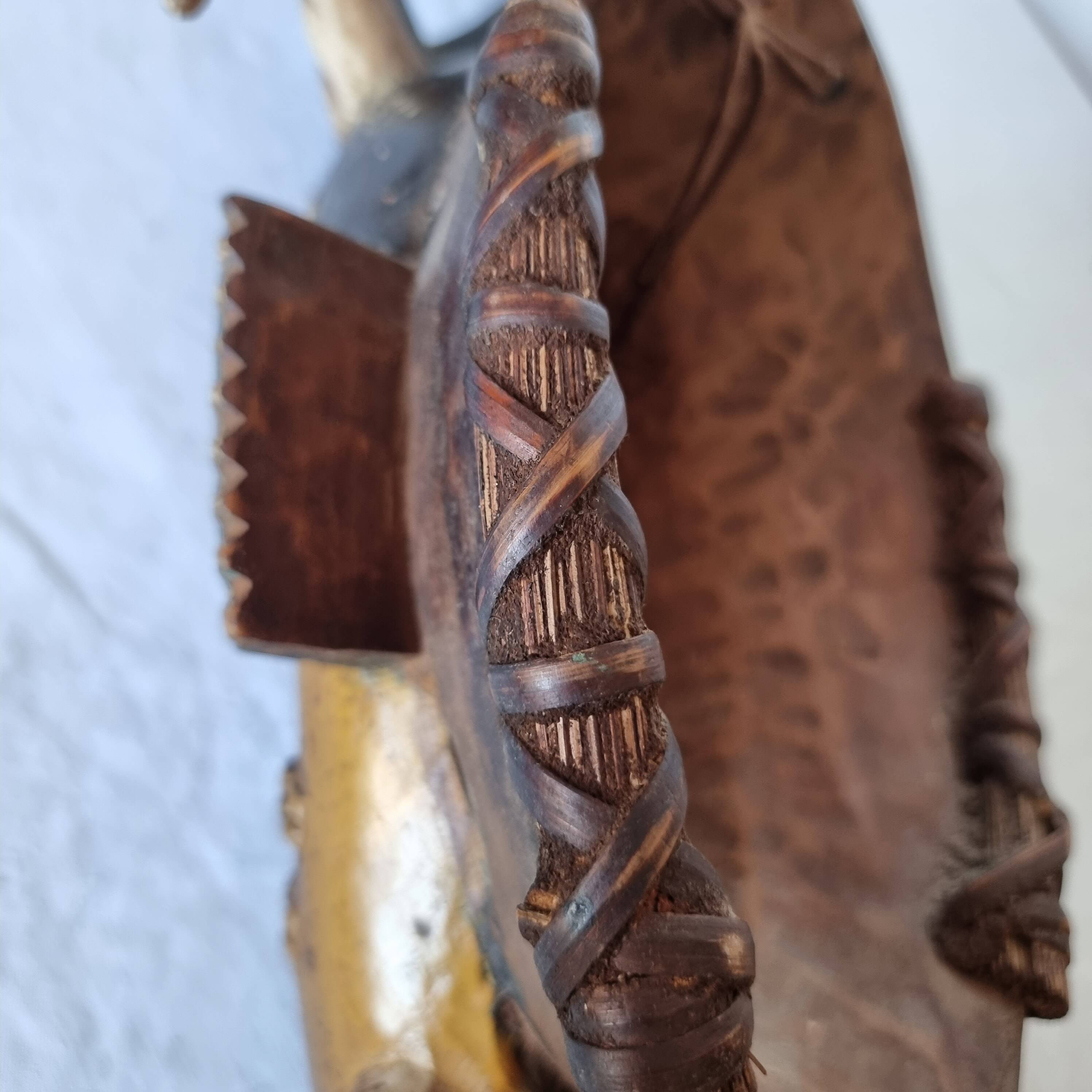 A large Senufo mask made of colored wood, decorated with an anthropomorphic figure