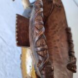 A large Senufo mask made of colored wood, decorated with an anthropomorphic figure