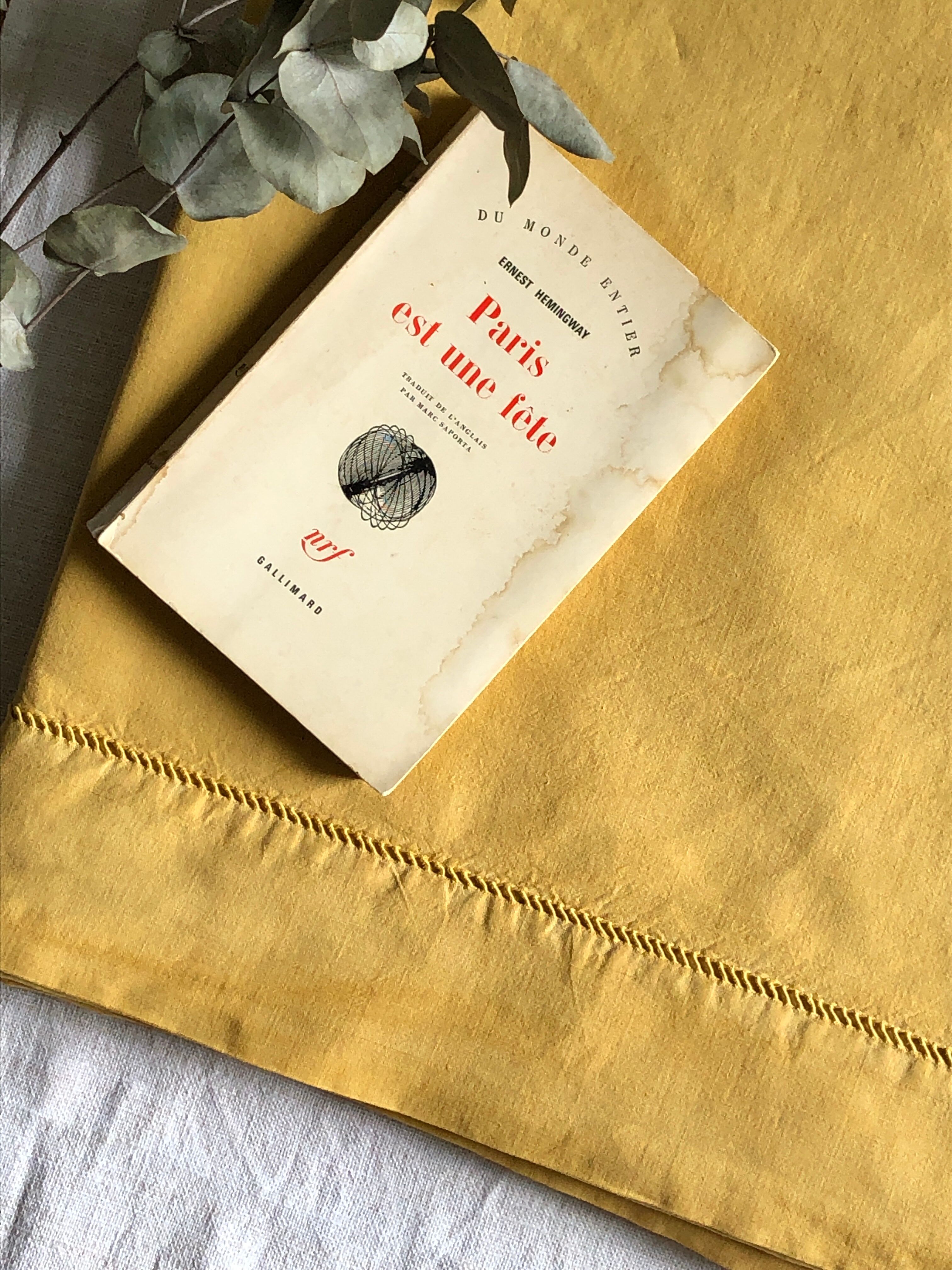 Old linen and cotton sheet tinted in curry yellow