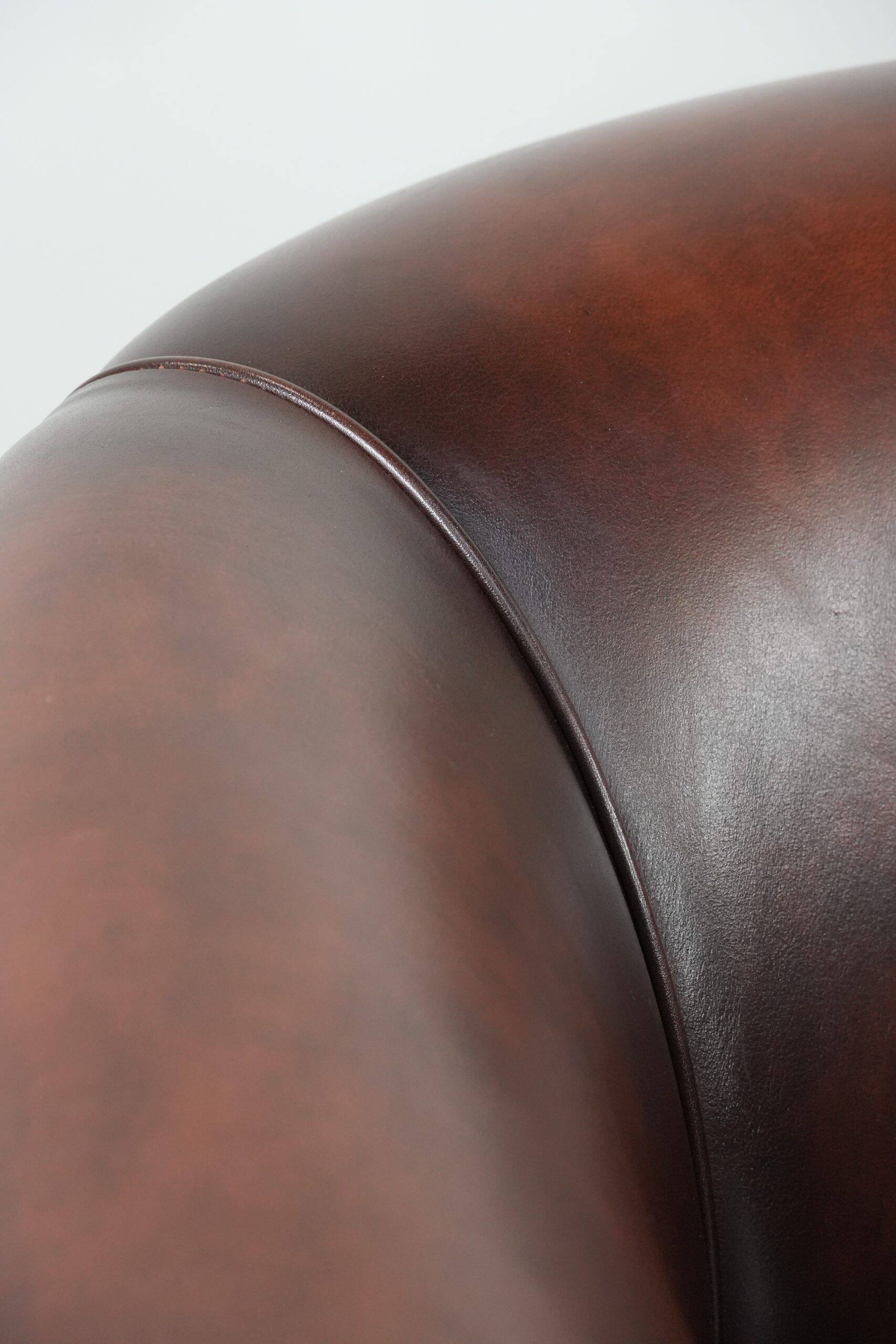 Set of two cow leather club armchairs in a luxurious red/brown colour