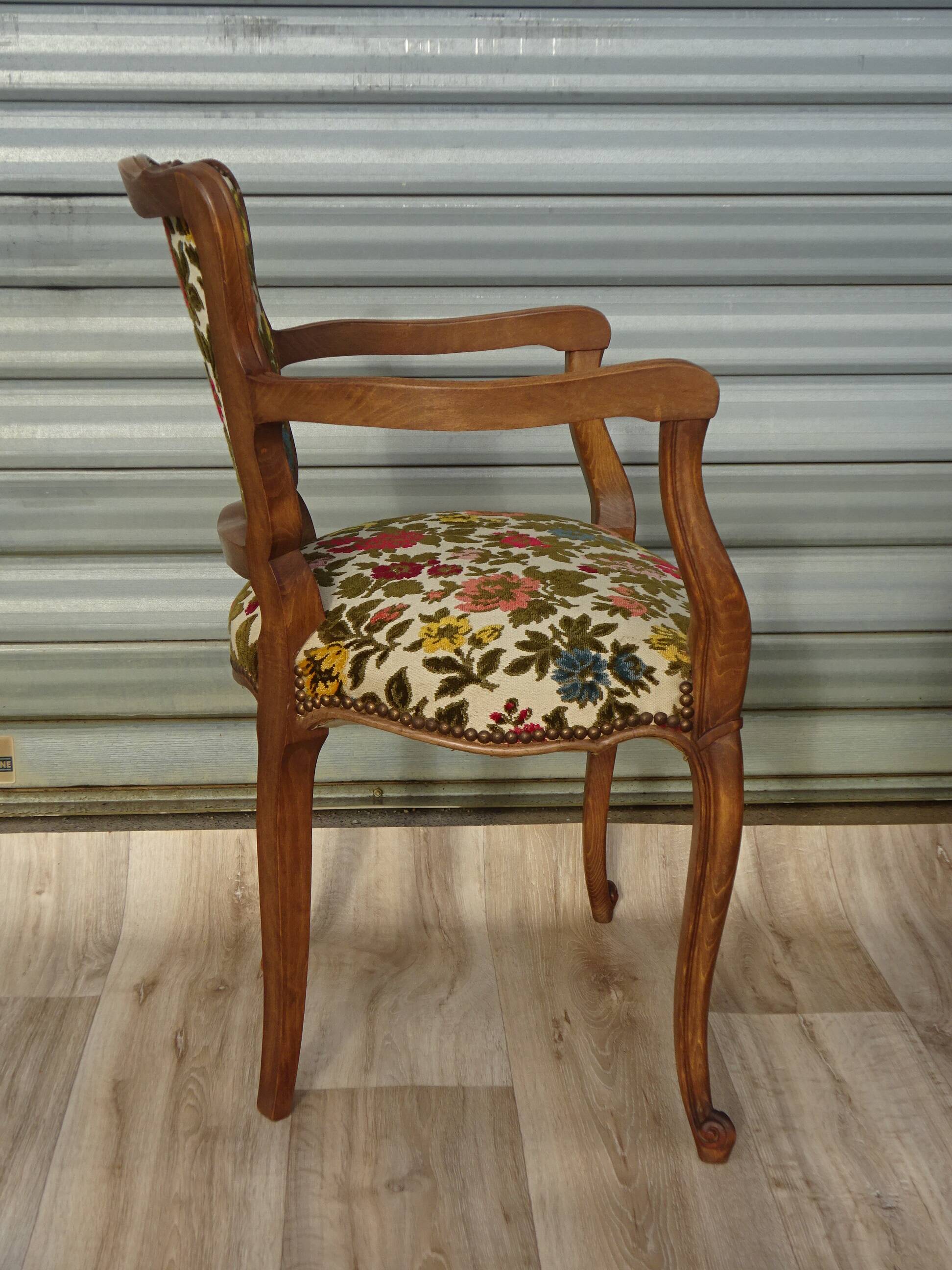 Convertible armchair with brocade fabric and floral patterns.