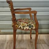 Convertible armchair with brocade fabric and floral patterns.