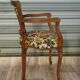 Convertible armchair with brocade fabric and floral patterns.