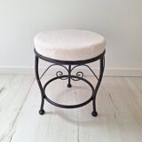 Black iron stool/pouf with its boucle fabric cushion.