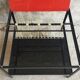 Modernist metal coffee table with a magazine rack in 1950s design.