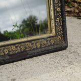 Mirror with black and gold frame, embossed vine leaves