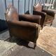 Pair of club armchairs in wood and leather, early 20th century.