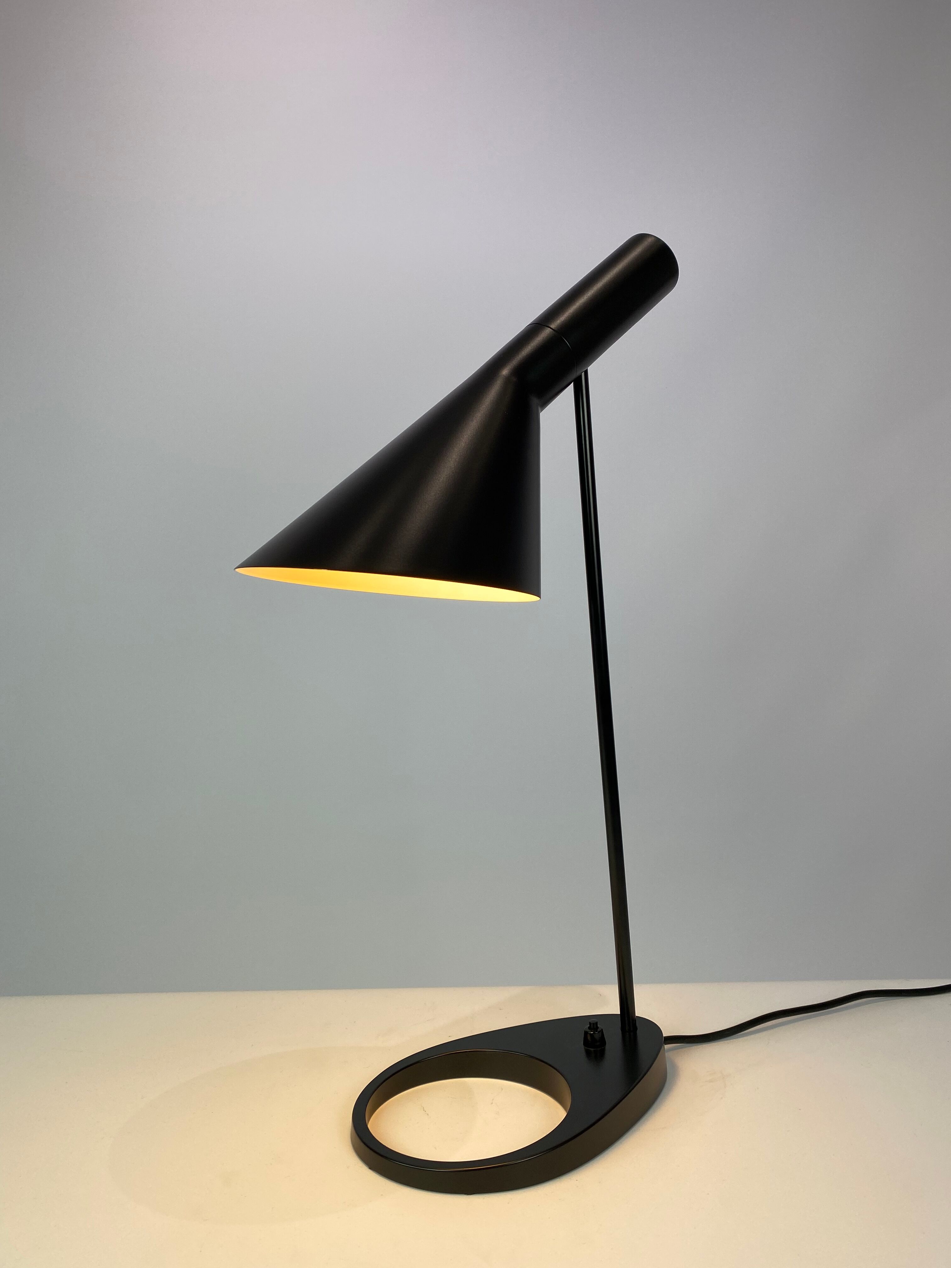 Black table lamp designed by Arne Jacobsen and manufactured by Louis Poulsen