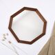 Old second-hand wooden mirror, octagonal shape.