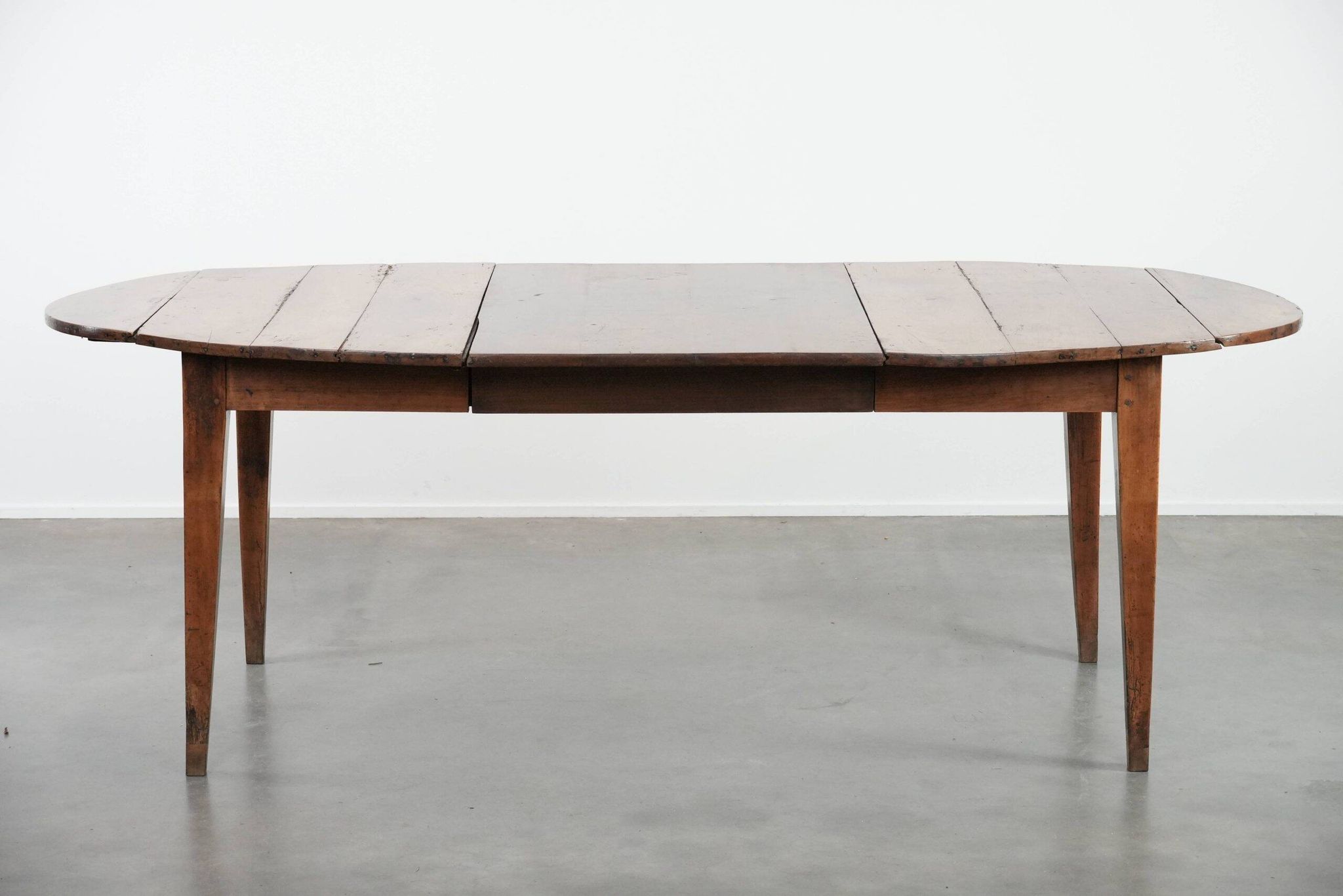 Rare antique oval French extendable dining table made of fruitwood