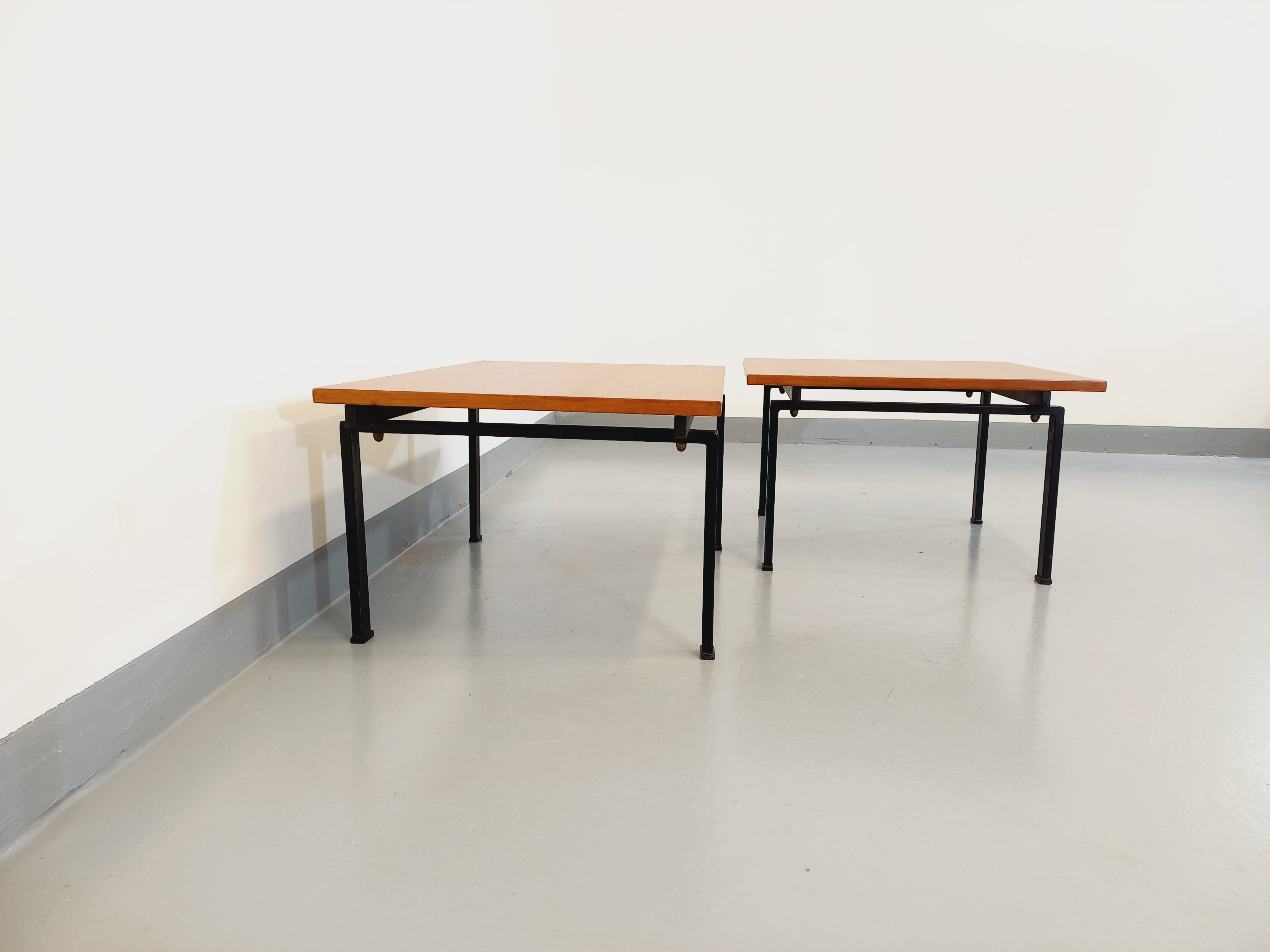 Suite of two vintage modernist Isa coffee tables in teak and black metal from the 60s