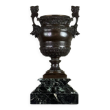 Patinated bronze vase with handles topped by bicéphalic busts, 19th century.
