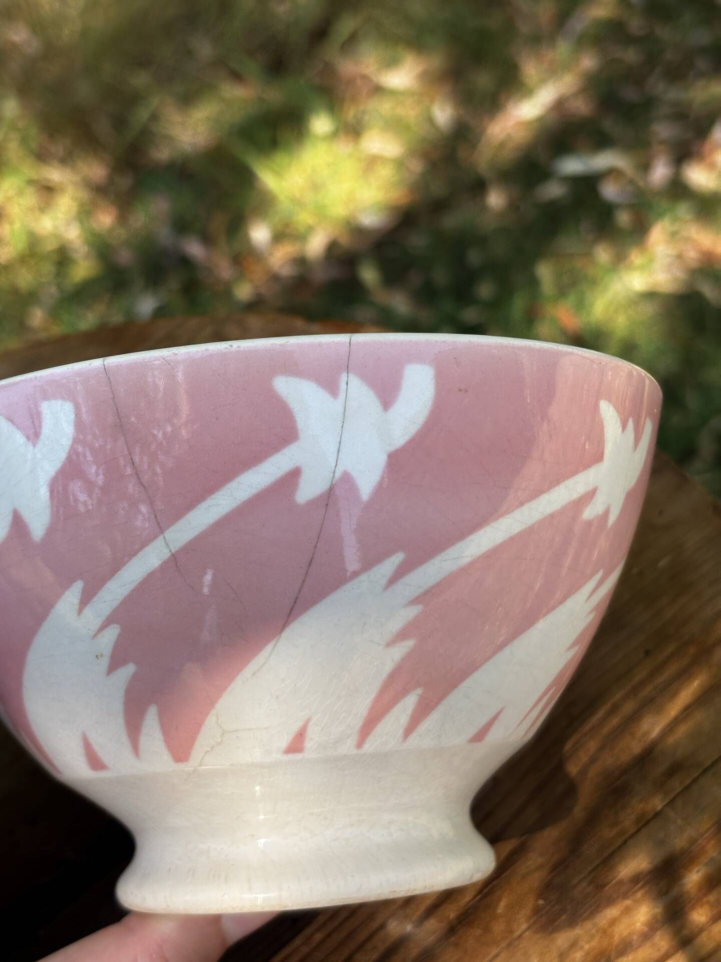 Old footed bowl in earthenware with pink decoration and defects.