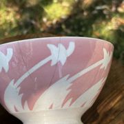 Old footed bowl in earthenware with pink decoration and defects.