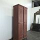 Red painted metal workshop locker with two doors.