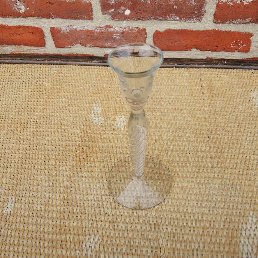 Old twisted transparent glass candlestick