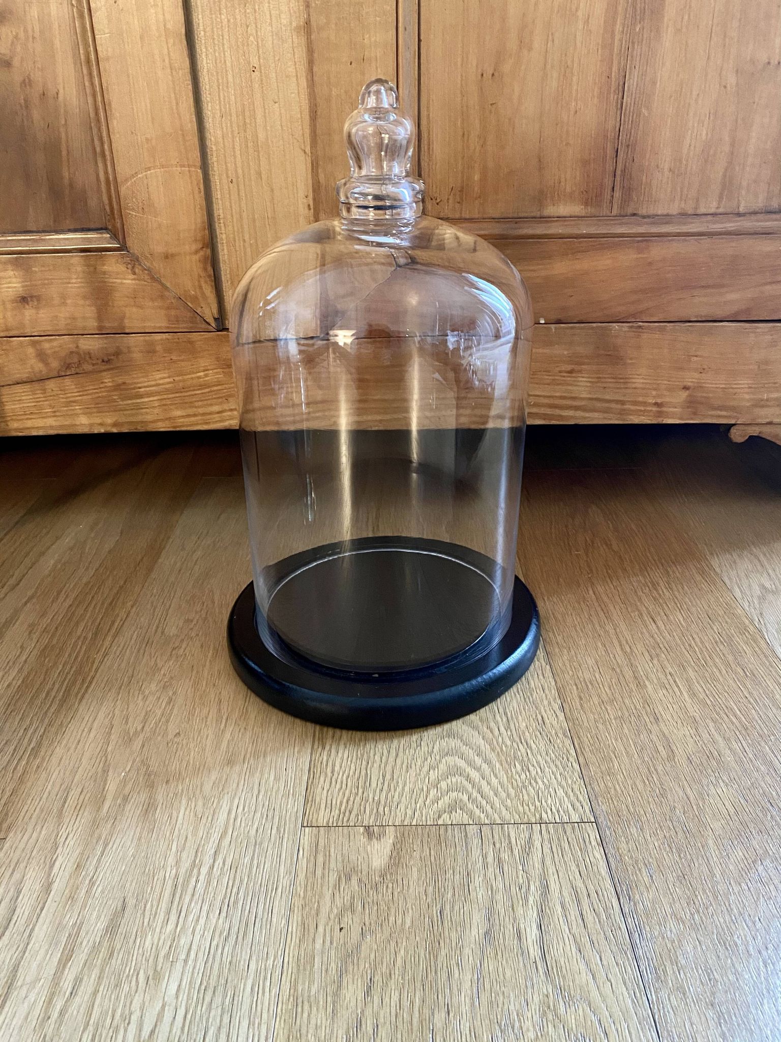 Large old glass bell and its wooden base