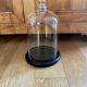 Large old glass bell and its wooden base