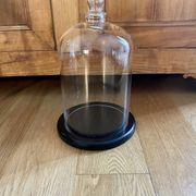 Large old glass bell and its wooden base
