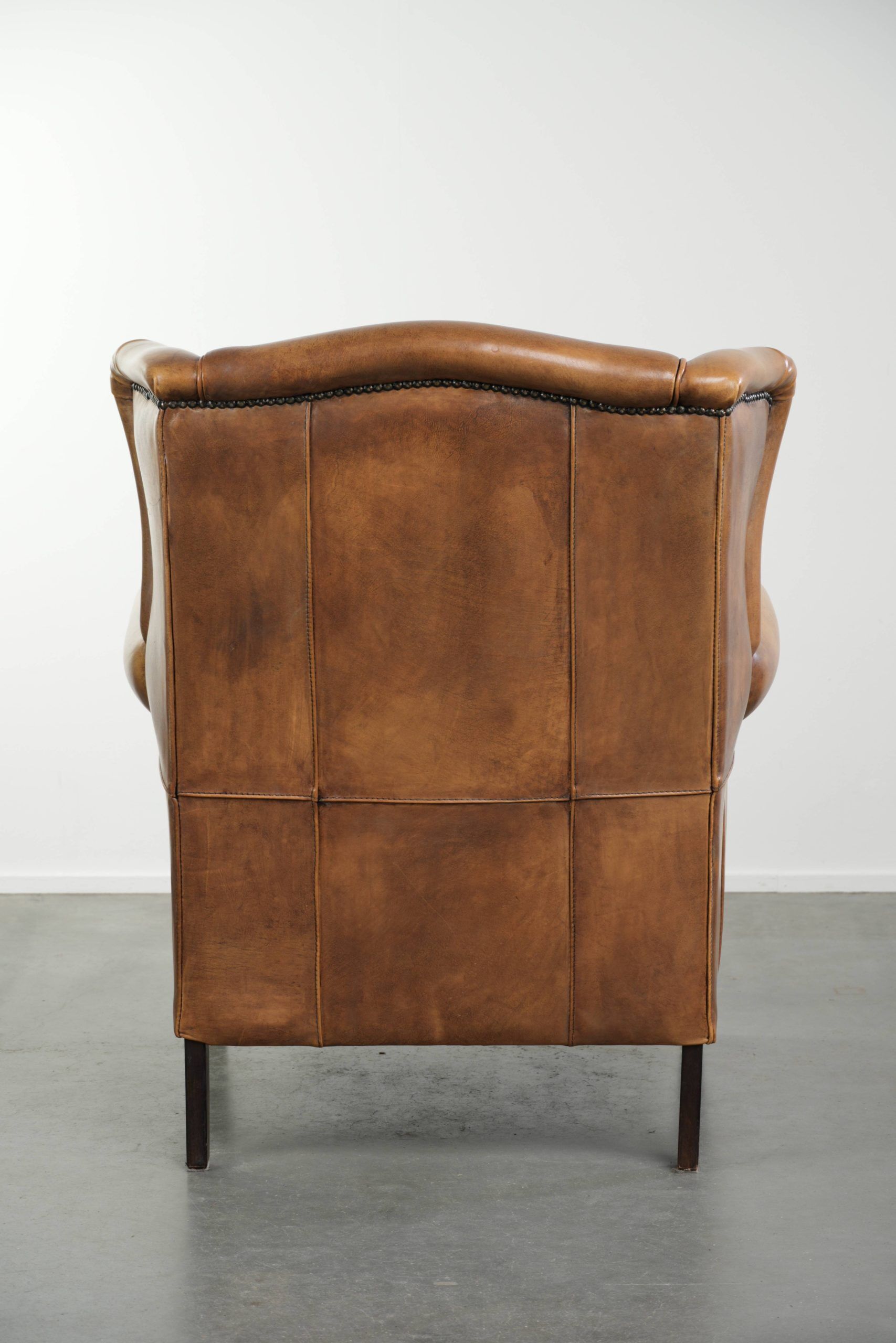 Comfortable cowhide wingback armchair with a timeless English look