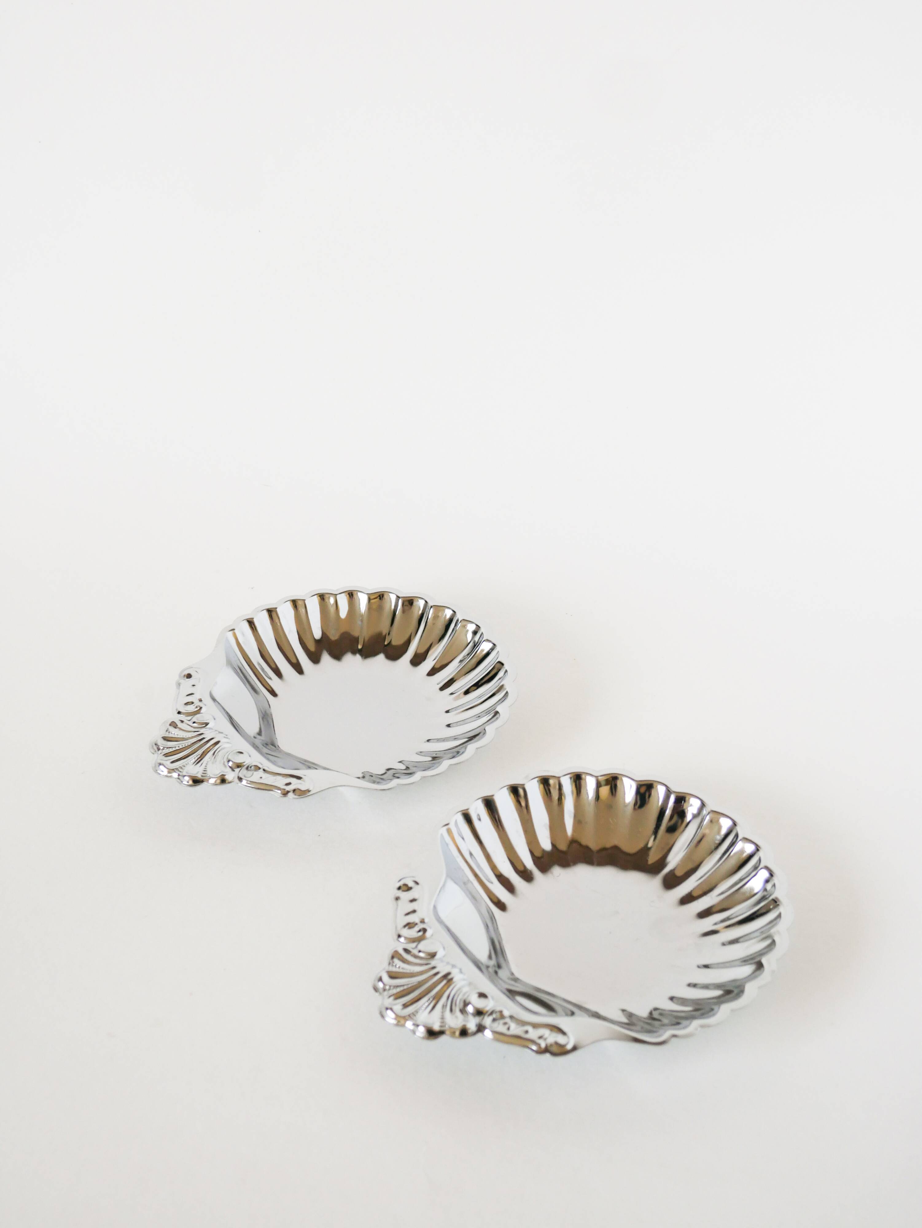 Pair of worked stainless steel shell trinket trays, 1970