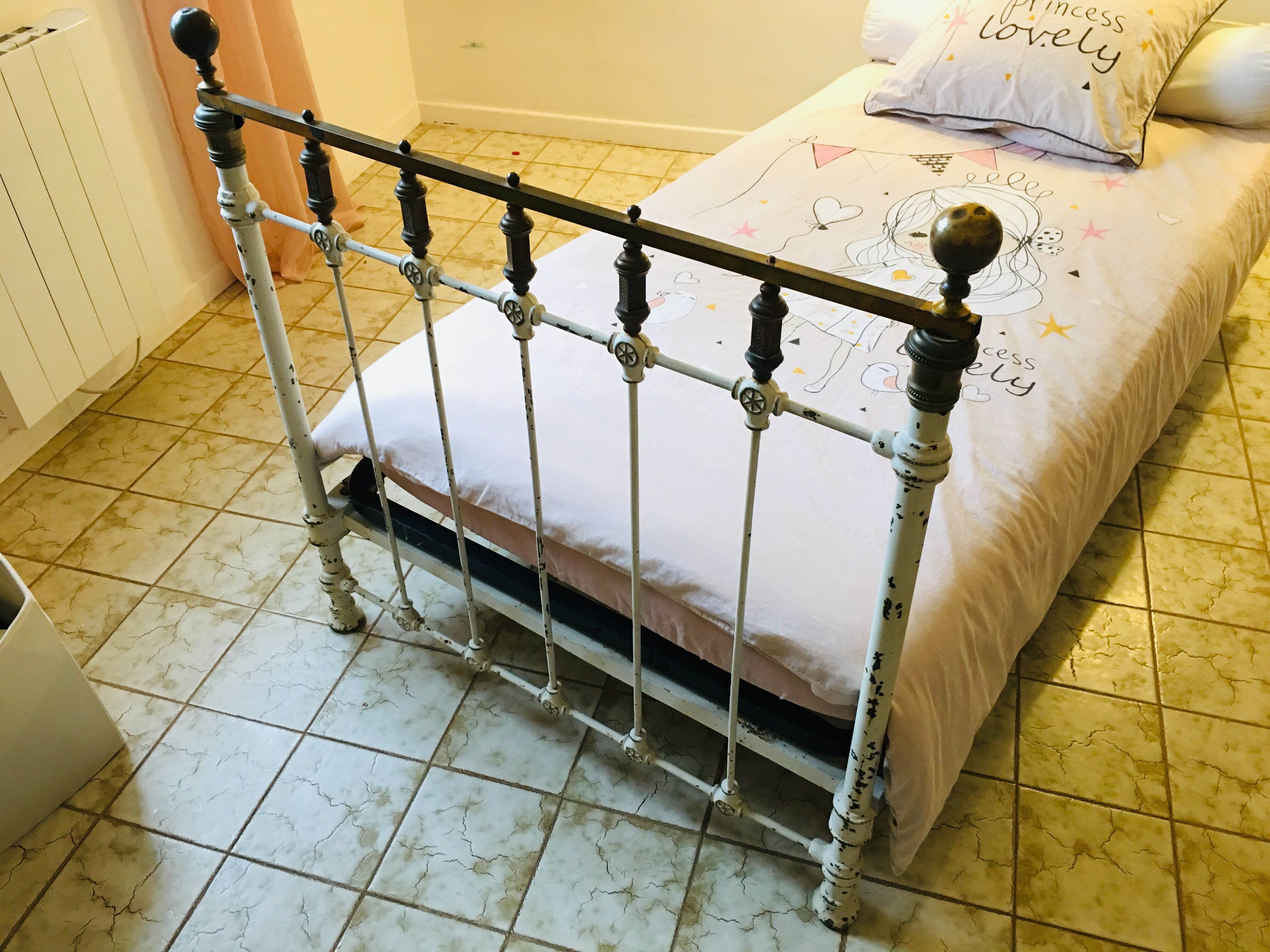 Old white metal and brass bed