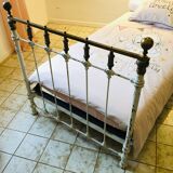 Old white metal and brass bed