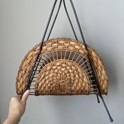 Vintage metal and wicker magazine rack, bohemian country decor.