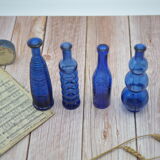 Set of 4 blue bottles of decoration