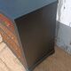 Vintage commode revamped in matte black & wood with warm tones.