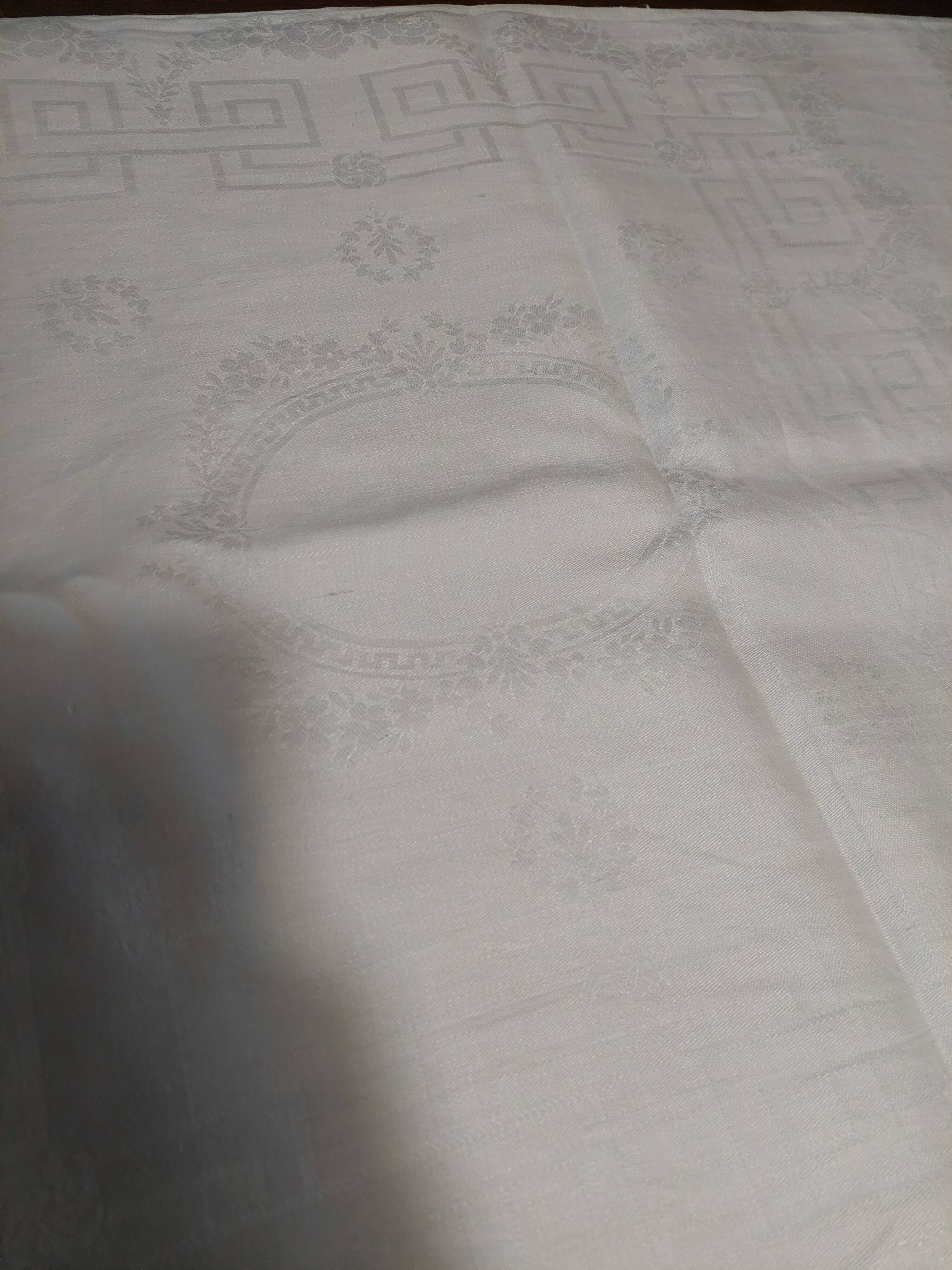 Table napkins set of eleven in a single piece damask linen and silk early 20th century.