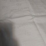 Table napkins set of eleven in a single piece damask linen and silk early 20th century.