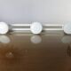 White lacquered metal wall coat rack with 3 hooks, 1970.