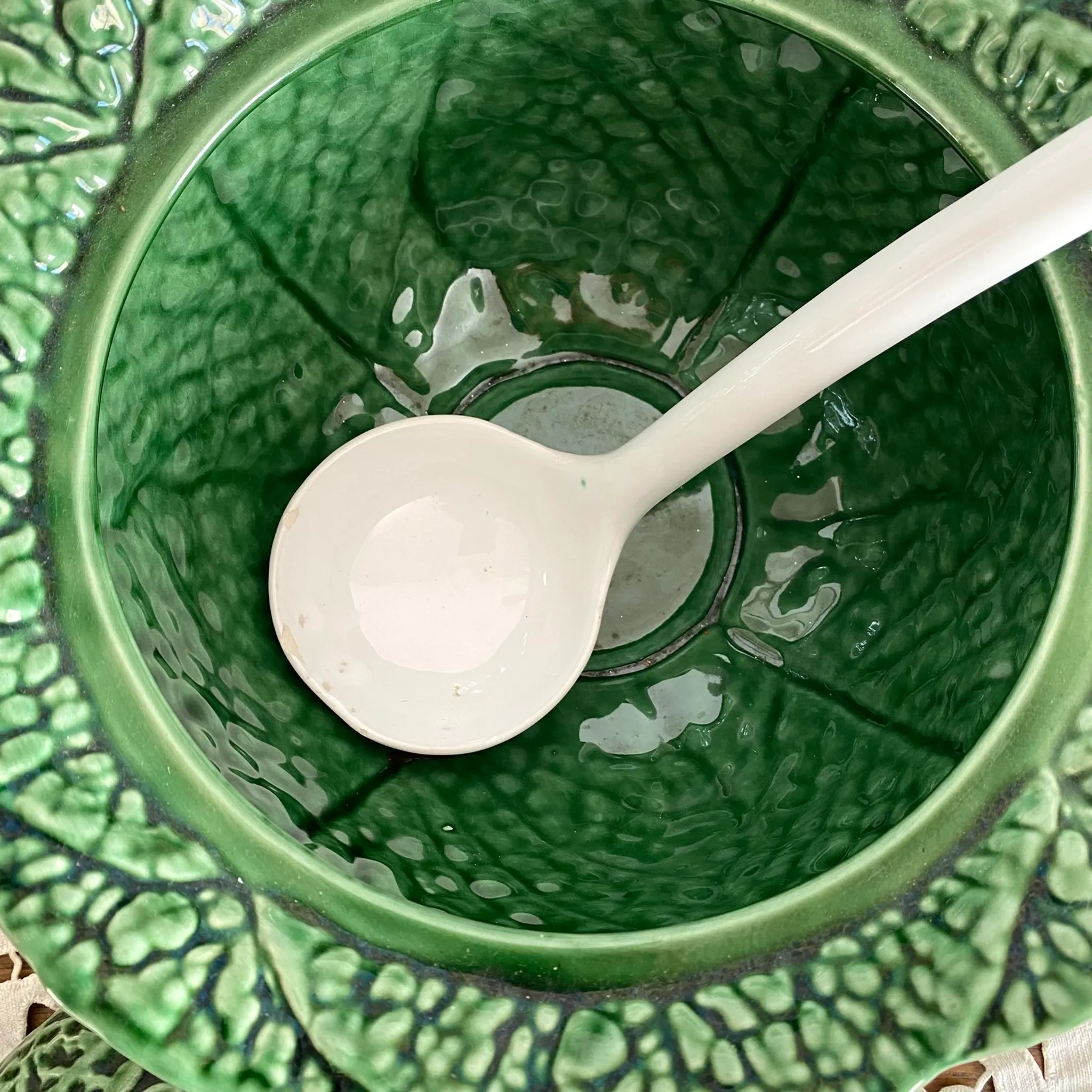 Large soup tureen in earthenware with a cabbage design, along with a dish and spoon.