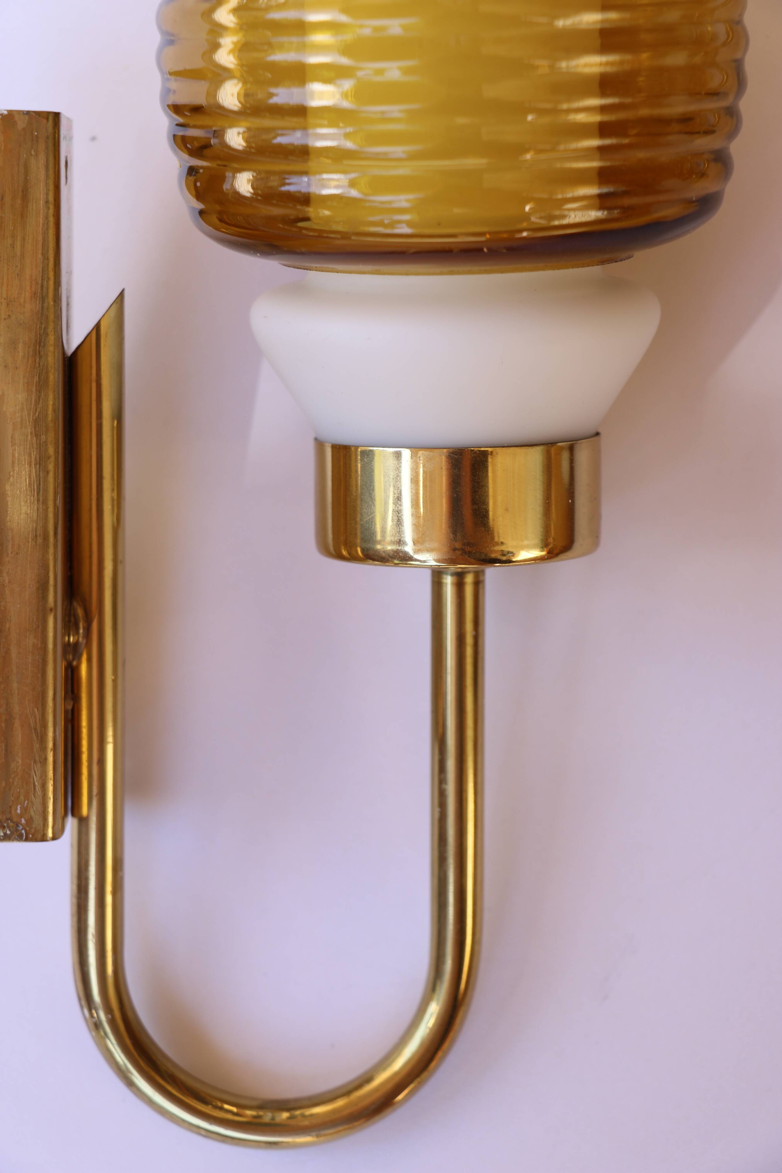 Pair of Scandinavian wall sconces, brass, opal glass and amber glass.