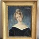 Portrait of young woman painting on wood