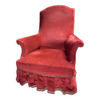 Bright red armchair with fringe