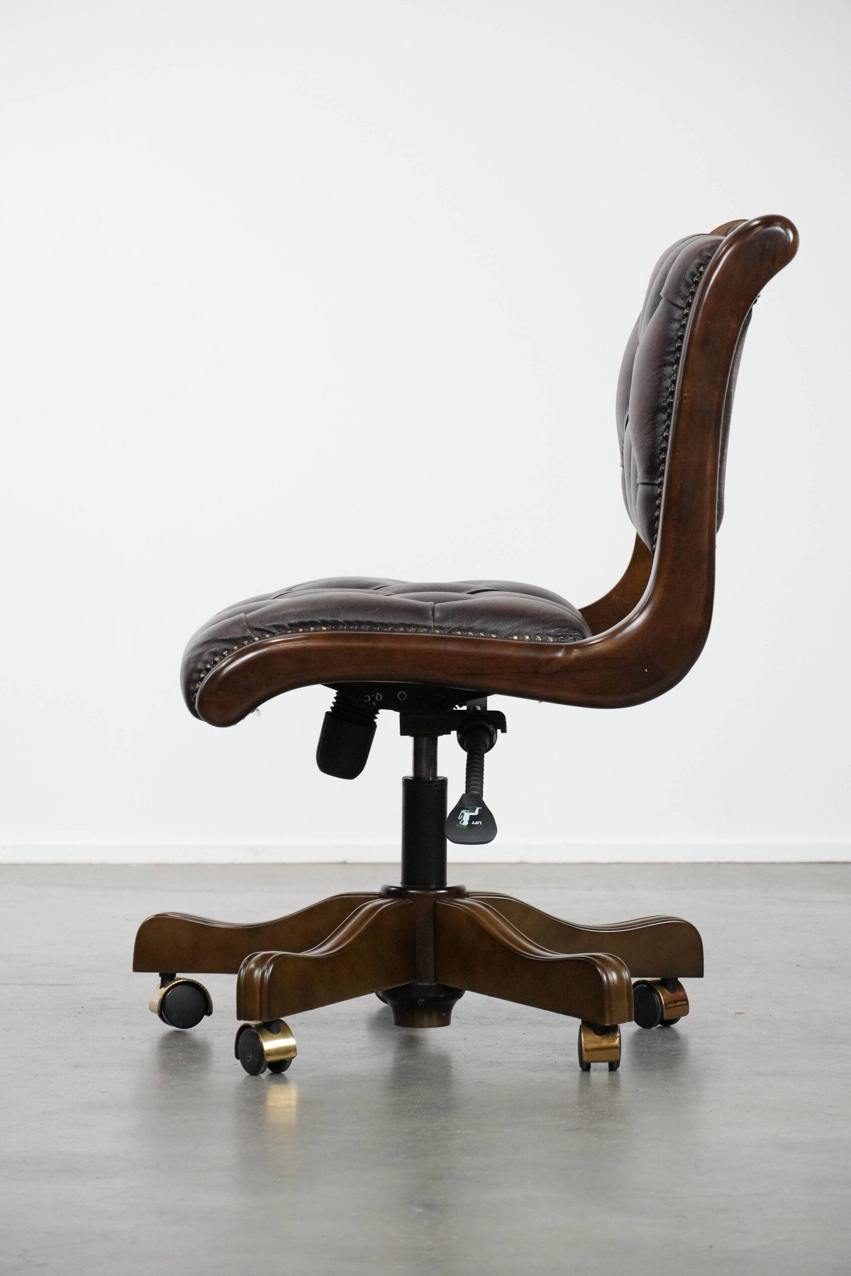 Chesterfield office chair in English style made of cow leather and wood.