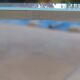 Long modern coffee table in glass and off-white metal - as new.