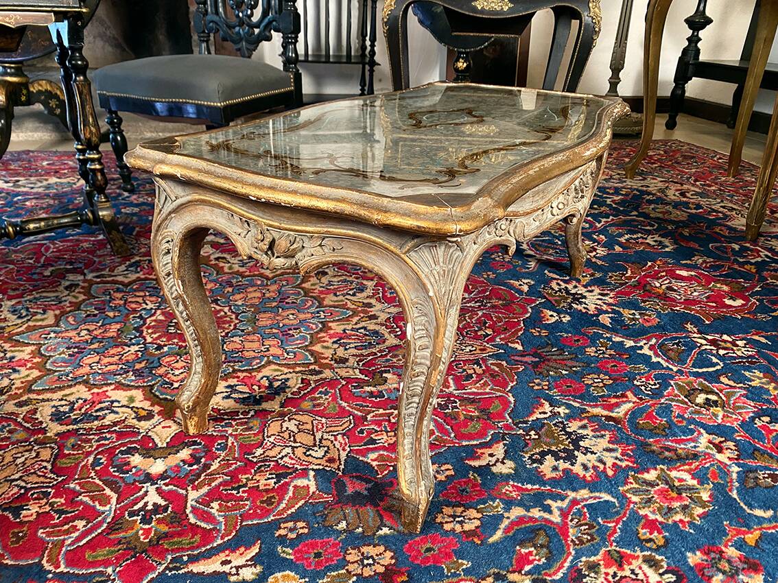 Louis XV style coffee table in carved wood with grey and gold highlights.