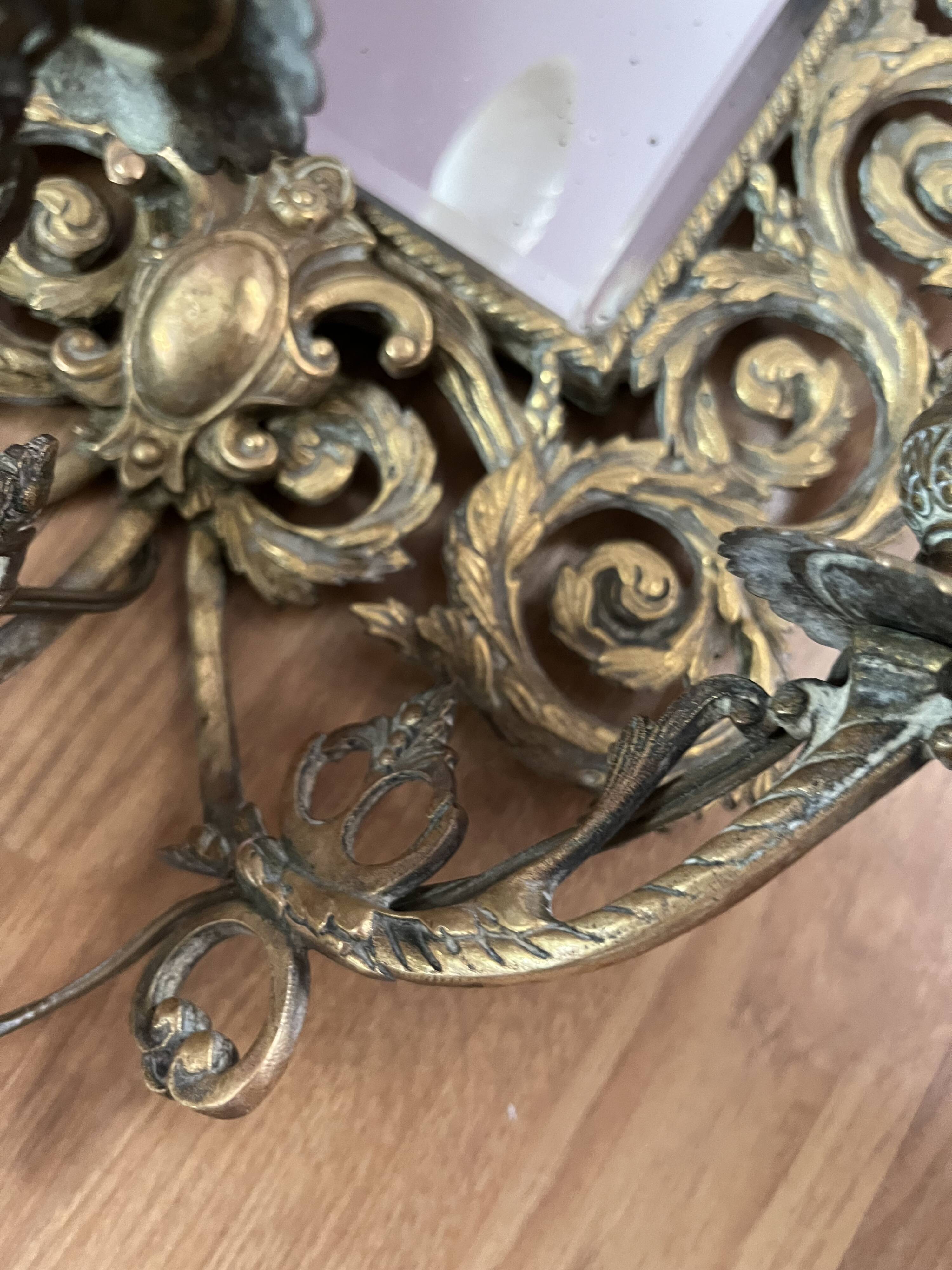 Pair of Napoleon III wall sconces, bevelled mirrors, mask heads.