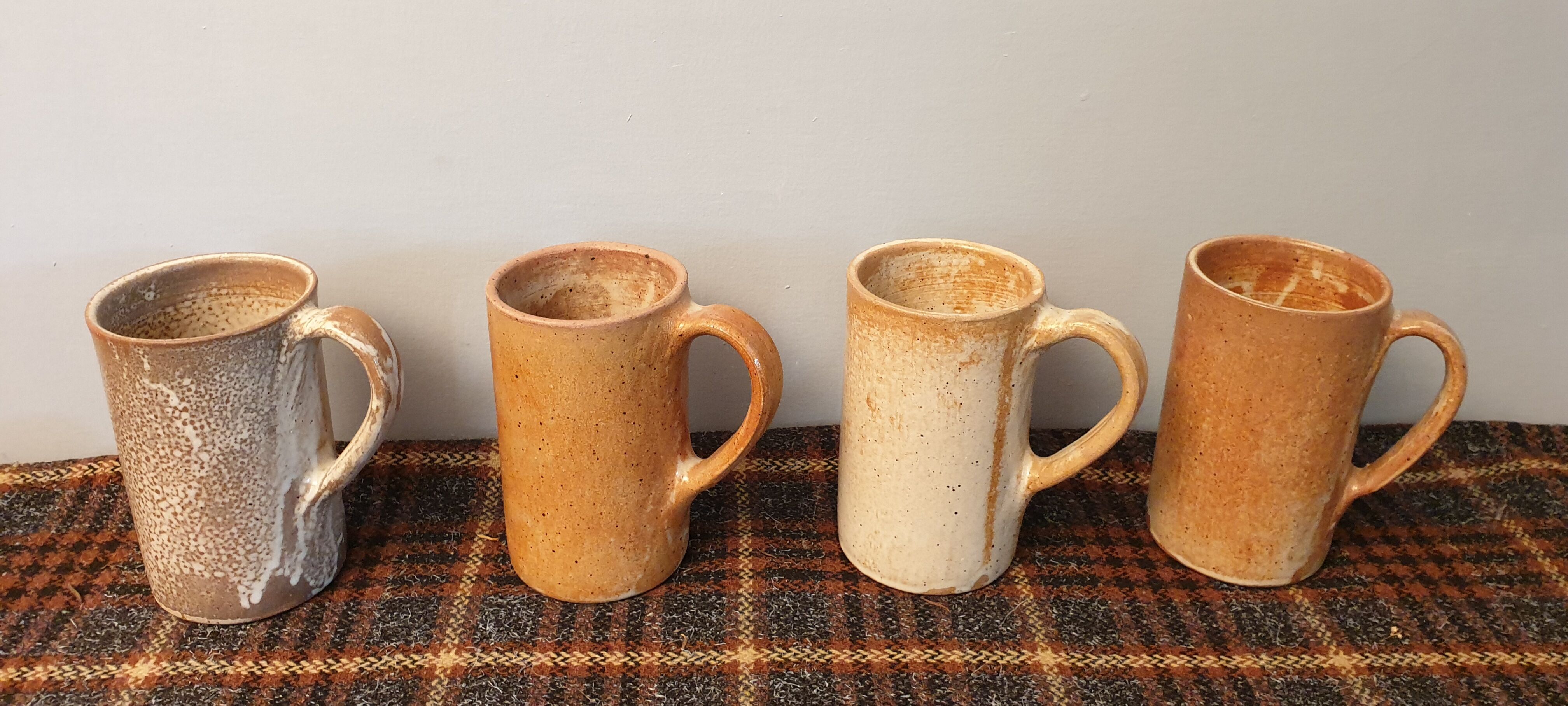 Suite of 4 sandstone mugs